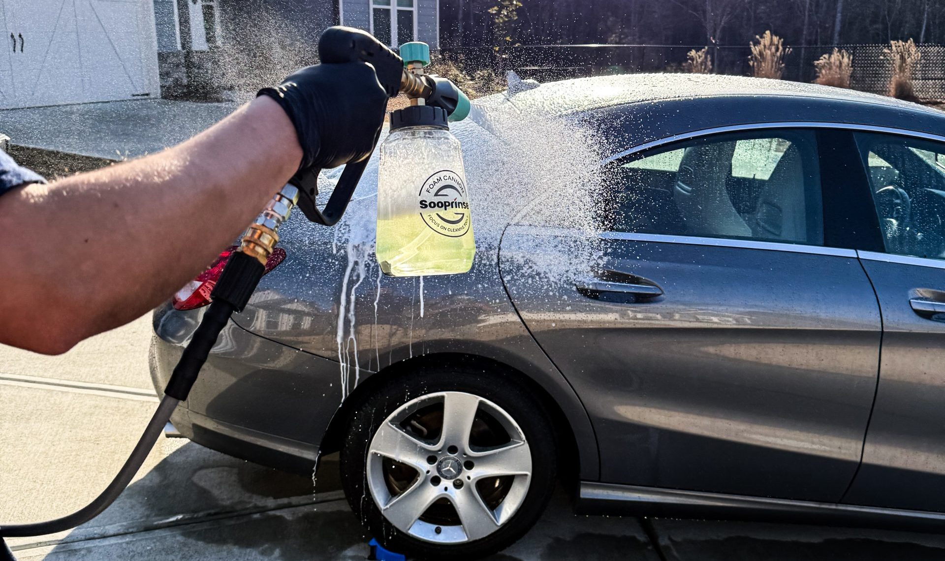 STO Detail technician applying a foam car wash with a foam cannon in Newnan, GA.