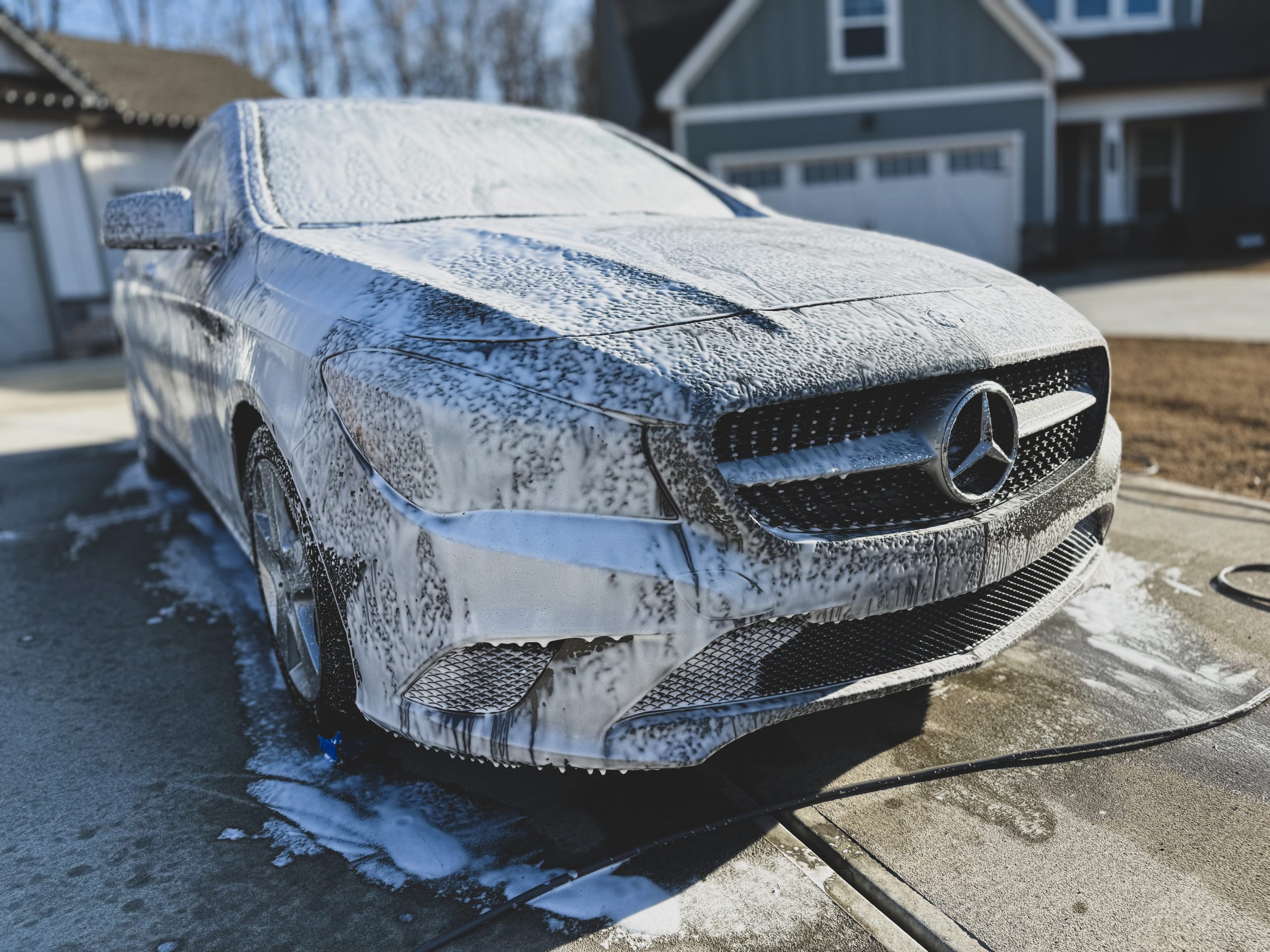 Mobile car detailing service by STO Detail applying foam to a Mercedes-Benz CLA in Tyron, GA
