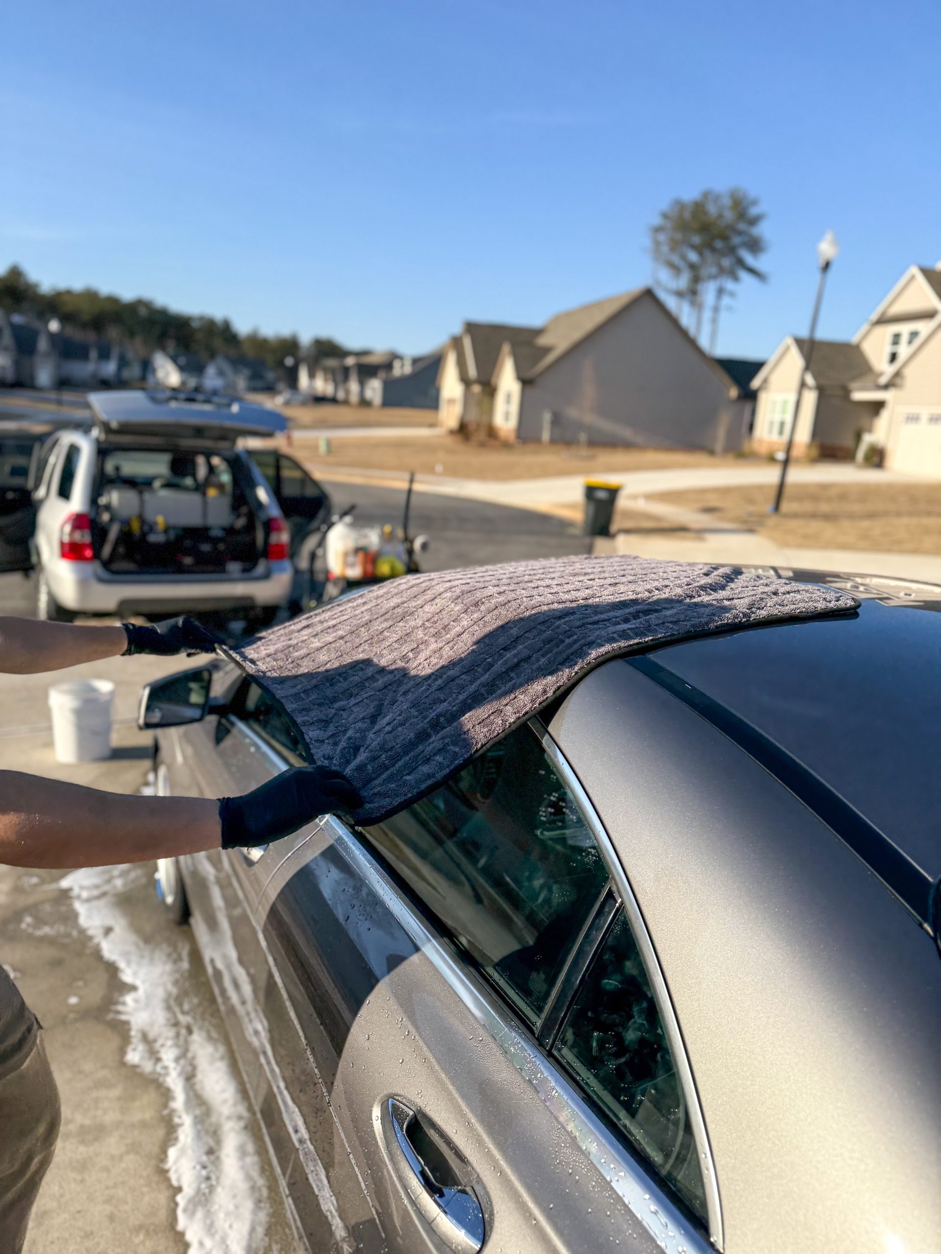 Mobile car detailing service by STO Detail drying a vehicle in Fayetteville
